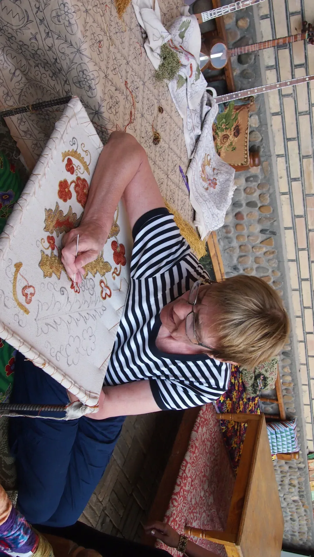 Suzani embroidery artisan creating traditional patterns